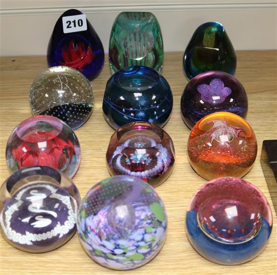 Twelve glass paperweights including some Caithness